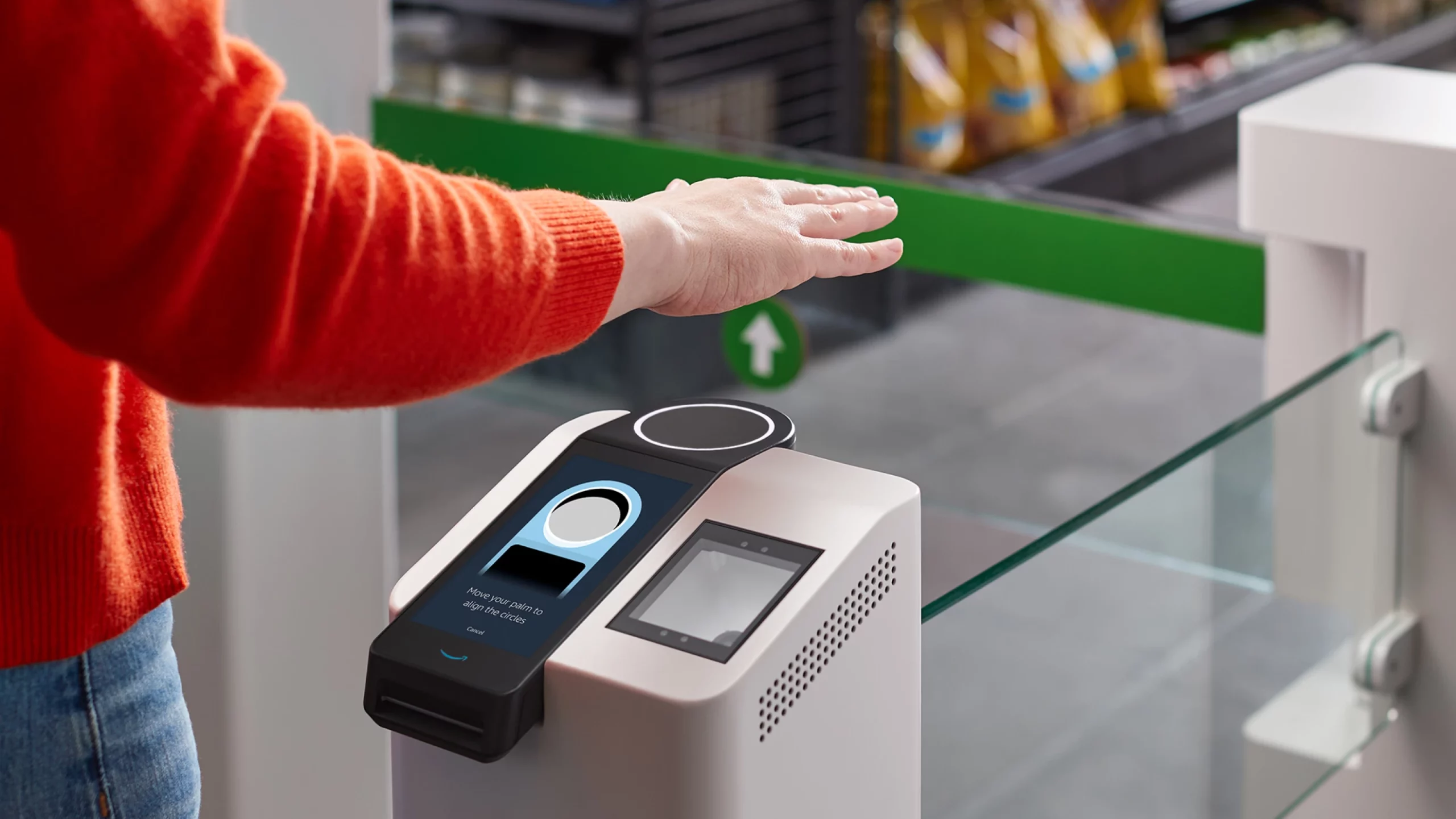 Customer using the Amazon One palm-scanning payment system for secure and efficient checkout